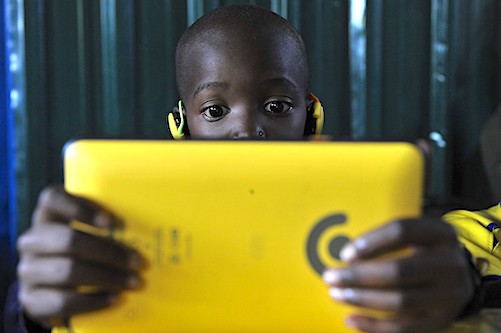 Pupils from Light House Grace academy use the Kio tablet created by the local technology company BRCK Education during a class sesssion in Kawangware, Nairobi on October 16, 2015. BRCK is a Nairobi- based hardware and services tech company whose flagship product is the BRCK, which is an internet connectivity device made for low infrastructure environments.The tablets customised for the little hands are fitted with features that suit lower class pupils from harsh environments.The BRCK Kio Kit provides a ìdigital classroom in a boxî model that connects any school within range of a mobile phone tower to the internet, as well as provides locally hosted content to the Kio tablets within each kit. AFP PHOTO/SIMON MAINA (Photo by Simon MAINA / AFP)