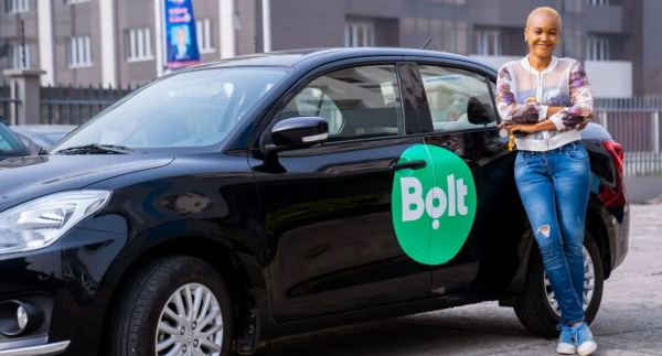Conductrice Bold posant devant une voiture de la startup